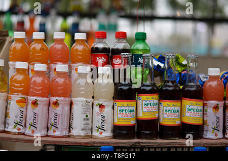 Bottles of global soft drink brands including products of Coca