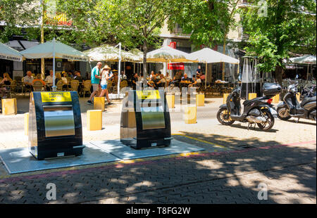 New trash disposal units in front of a cafe in the Alameda de Hercules in Seville Stock Photo