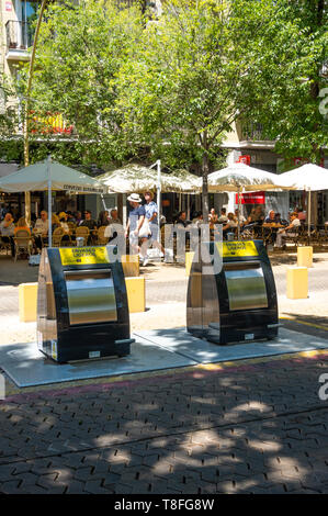 New trash disposal units in front of a cafe in the Alameda de Hercules in Seville Stock Photo