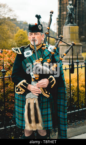 Traditional scottish bagpiper in full dress code in Edinburgh Stock Photo