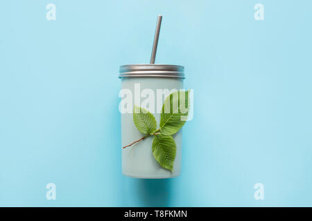 Top view of a reusable jar with a metal lid and a straw for summer drinks. Reusable application. Individual use. Save the planet. Zero waste. Stock Photo