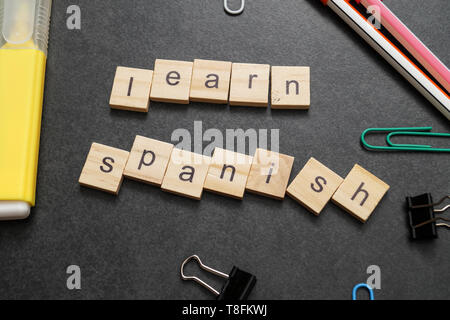 Word LEARN SPANISH written on wood block. Close up Stock Photo