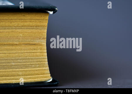 Book on dark blue background. Soft focus Stock Photo