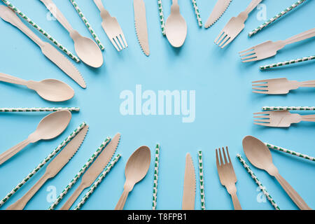 Disposable tableware from natural wooden materials, spoon, knife, and fork, eco-friendly. Space for text. Stock Photo