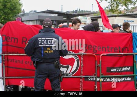 Pforzheim, Germany. 11th May, 2019. A police officer watches the counter protest. Around 80 people participated in a march through Pforzheim, organised by the right-wing party ‘Die Rechte' (The Right). The main issues of the march was the promotion of voting for Die Rechte' in the upcoming European Election and their anti-immigration policies. They were confronted by several hundred counter-protesters from different political organisations. Credit: Michael Debets/Pacific Press/Alamy Live News Stock Photo