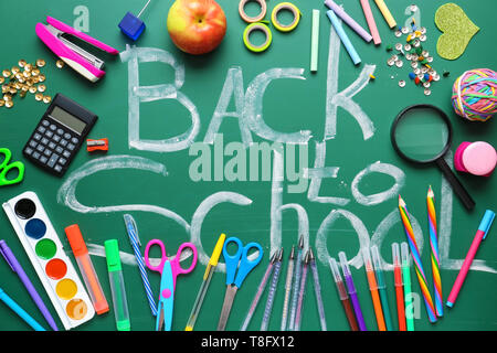 Set of stationery and words BACK TO SCHOOL on chalkboard Stock Photo