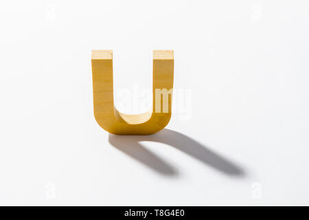 Wooden Alphabet U and Shadow Reflection. Stock Photo