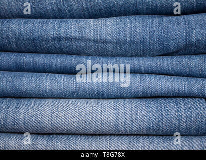stack of various shades of jeans as background Stock Photo