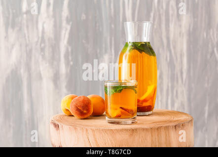 Peach cocktail in glassware on wooden table Stock Photo