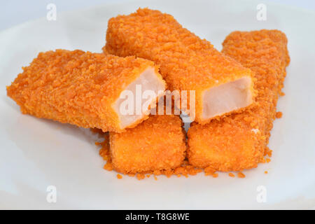 Fish Fingers, Fish Sticks on a white plate. Studio picture against a white background Stock Photo