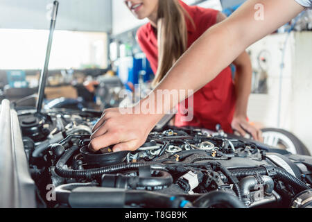 Hand of an auto mechanic checking the car of a customer Stock Photo