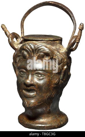 A Roman ointment vessel shaped like a Satyr's head, 2nd century A.D. Bronze with greenish patina. Vessel shaped like the three-dimensional head of a young Satyr with chin beard, pointed ears and curly hair. Two loops on the side with intact carrying handle, hinged, round lid. Height without handle 9 cm. Provenance: Private collection in the USA, ex Christie's, New York, 12 December 2002. Before that part of an English private collection since 1978. historic, historical, Roman Empire, ancient world, ancient times, ancient world, Additional-Rights-Clearance-Info-Not-Available Stock Photo