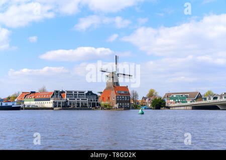 Historic Dutch Windmill in Zaanse Schans on the Zaan River in the Netherlands Stock Photo