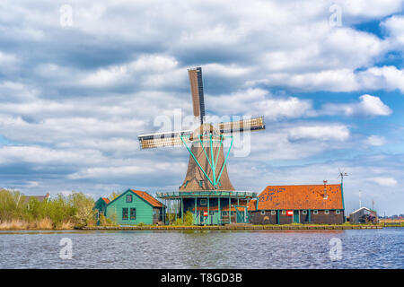 Historic Dutch Windmill in Zaanse Schans on the Zaan River in the Netherlands Stock Photo