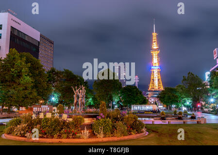 Odori park, the central park, with dance woman statues stand and fountain decorated in front of TV Tower. Sapporo, Hokkaido, Japan Stock Photo