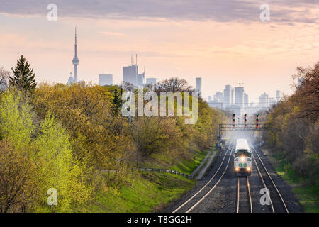 An eastbound GO Train approaches Danforth Station in Toronto's East End near sunset. Stock Photo