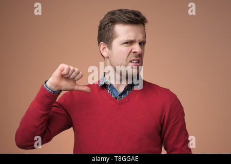 Young man pointing finger at himself. Studio shot Stock Photo