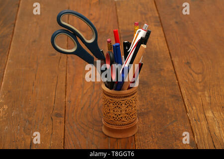 A glass of their birch bark to store pencils and ballpoint pens Stock Photo