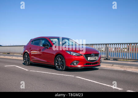 Red 2016 Mazda 3 Sport Black saloon on the seafront promenade, Southport, Merseyside, UK Stock Photo