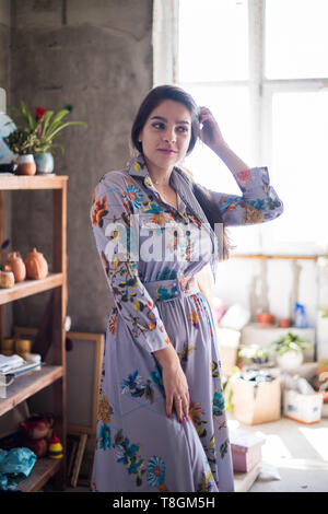 Beautiful lady artist standing in her studio, creative business owner Stock Photo