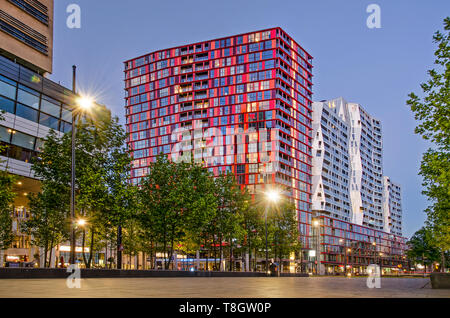 Rotterdam, The Netherlands, May 12, 2019: downtown Kruisplein square in the blue hour with the red and white, somewhat oddly shaped Calypso residentia Stock Photo