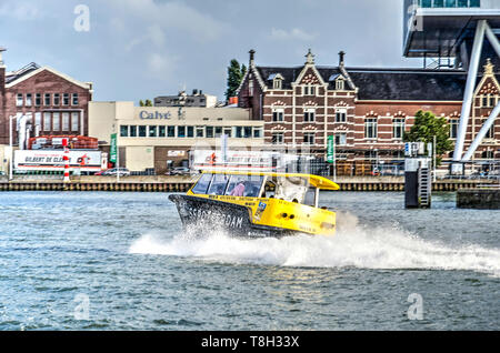 Rotterdam, The Netherlands, August 13, 2018: watertaxi on a curved trajectory on Nieuwe Maas river near Calve factory and Unilever office Stock Photo