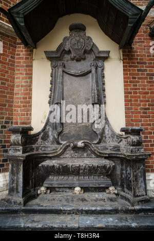 Ancient Christian church of Saint Mary from Krakow city in Poland built in gothic style.Marble stone skull statue in exterior of old catholic temple i Stock Photo