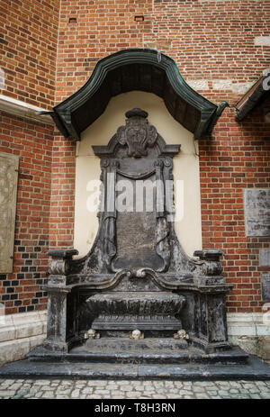 Ancient Christian church of Saint Mary from Krakow city in Poland built in gothic style.Marble stone skull statue in exterior of old catholic temple i Stock Photo