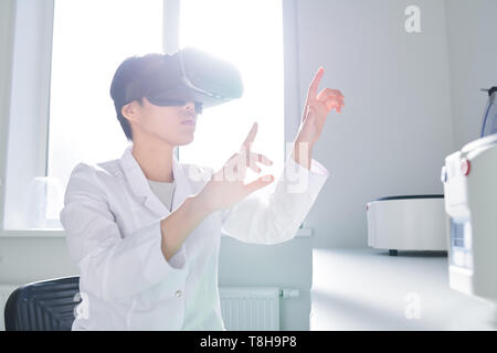 Asian innovation scientist using VR simulator Stock Photo