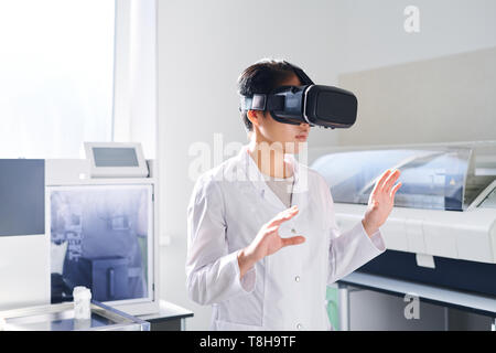 Young laboratory scientist in VR simulator Stock Photo