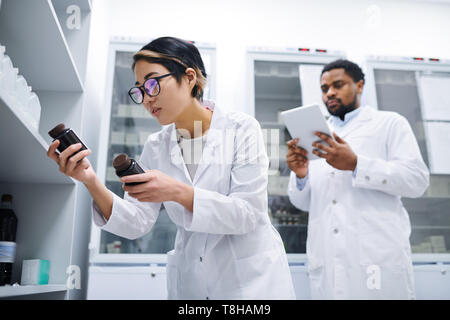 Lady doctor checking medications Stock Photo