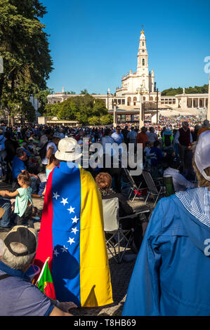 Fatima, Portugal - May 12, 2019: Woman with the flag of Venezuela behind her back in the Shrine of Fatima, Portugal. Stock Photo