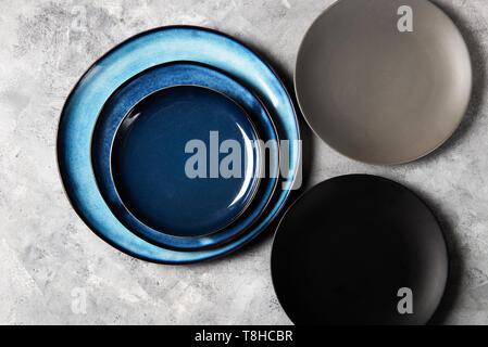 Empty Blue Plates on Grey Background Stock Photo
