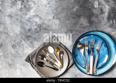 Empty Blue Plates on Grey Background Stock Photo