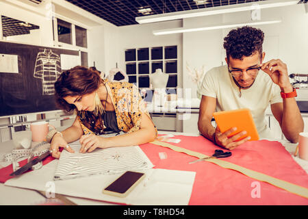 Two designers in process of creating new collection. Stock Photo