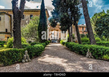 The old entrance of Casale di San Pio V (Saint Pio V House) opening to the Italian Garden of the park and the symbols of Chigi Family that bought the residence in the seventeenth century, in Rome, Italy Stock Photo
