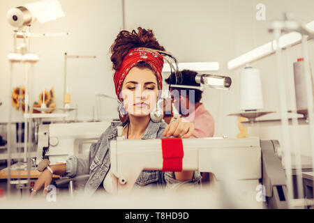 Two young tailors working on sewing machines Stock Photo