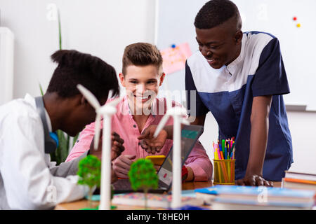 Students smiling while having brainstorming preparing homework Stock Photo