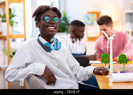 Dark-skinned student feeling cheerful after studying with friends Stock Photo