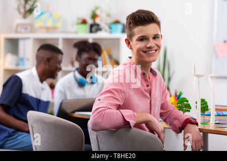 Teenager feeling motivated after studying with ark-skinned friends Stock Photo
