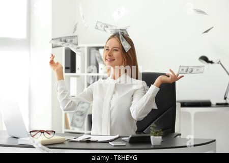 Successful businesswoman with lot of money in office Stock Photo