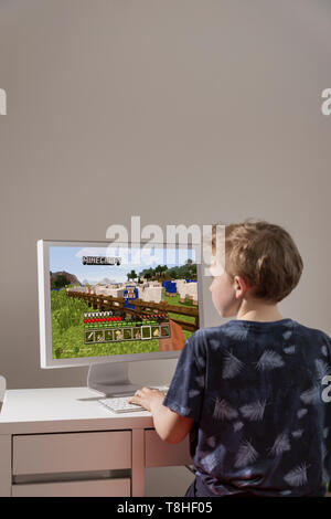 Boy playing the computer game minecraft Stock Photo