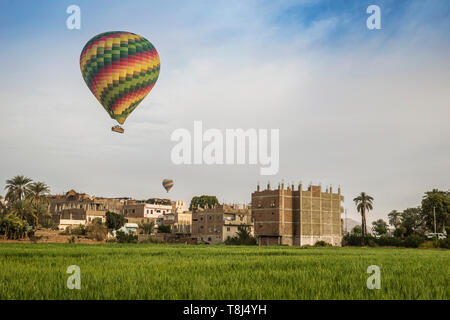 Hot air balloons flying over city, Luxor, Egypt Stock Photo