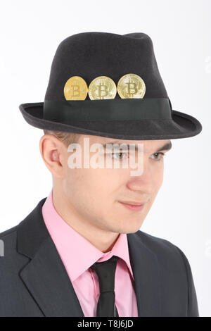 Bitcoin in a felt men's hat isolated on white background. High resolution photo. Full depth of field. Stock Photo