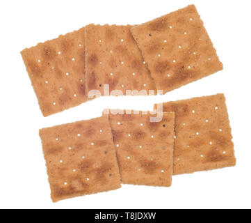 Horizontal shot of six whole-wheat crackers in two rows of three each.  White background.  Isolated on white.  Holes in the crackers. Stock Photo