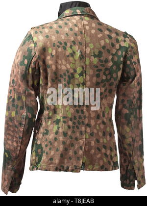 A field tunic M 43 for a camouflage suit Drill cloth imprinted on one side in 'pea pattern' camouflage, grey-painted zinc buttons, inner reinforcement and bandage pack pocket (raddled) of imitation silk, the silhouette of the sleeve eagle clearly visible. historic, historical, 20th century, 1930s, 1940s, Waffen-SS, armed division of the SS, armed service, armed services, NS, National Socialism, Nazism, Third Reich, German Reich, Germany, military, militaria, utensil, piece of equipment, utensils, object, objects, stills, clipping, clippings, cut out, cut-out, cut-outs, fasc, Editorial-Use-Only Stock Photo