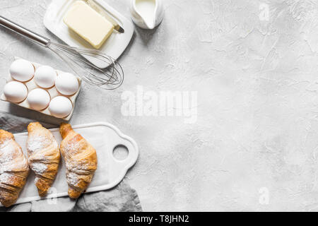 Concept recipe classic croissant with ingredients for cooking dough. Baking background. Food accessories. Top view. Flat lay. Copy space for text. Stock Photo