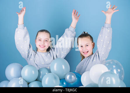 Sisters organize home party. Having fun concept. Balloon theme party. Girls best friends near air balloons. Birthday party. Happiness and cheerful moments. Carefree childhood. Start this party. Stock Photo