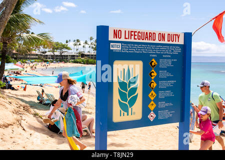 A sign on the Napilli Kai Resort warning people that no lifeguards are on duty, Maui, Hawaii, USA.