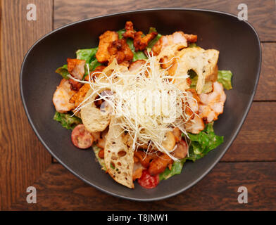 Appetizer with grilled chicken, cheese and croutons shot from above Stock Photo